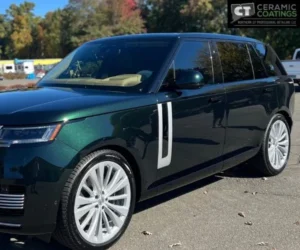 dark metallic green Range Rover SUV parked outdoors in a paved lot, showcasing paint protection film in Ellington